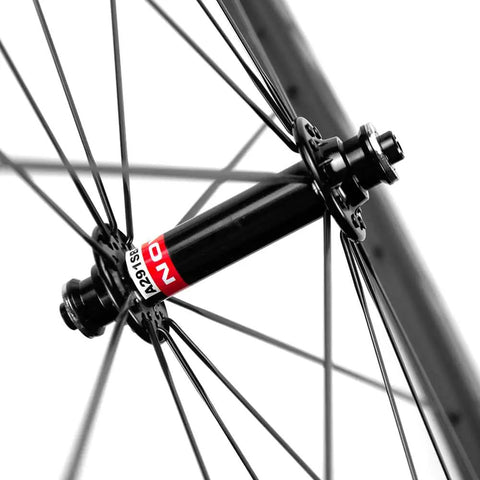Close-up of hub and spokes on carbon wheelset for road bikes 700C with front 50mm, rear 88mm depth, U shape 25mm width, basalt brake surface.