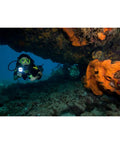 Scuba diver using Light Cannon ELED L1 Dive Light With Pistol Grip Safety Yellow 1100 Lumens exploring underwater cave