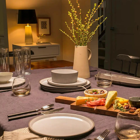 LED Light Bulbs 40 Watt Equivalent Soft White Frosted Candle Lights illuminate a cozy dining room setup with plates and cutlery.