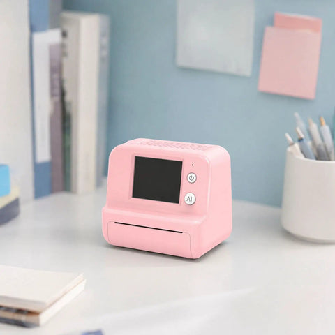 Totally Rad Pink Mini Thermal Printer With AI Voice Recognition And Built In Display on a desk with books and stationery.