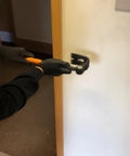 Using Heavy Duty Indexing Crowbar And Nail Puller Wrecker Tool for removing trim with gloves on a wall.