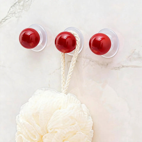 Three red round self-adhesive knobs on wall; part of Eight Pack Self Adhesive Red Round Cabinet Knobs Peel And Stick Handles For Glass Doors Refrigerators Cabinets And Drawers No Drill Needed Easy Install Durable Adhesive.