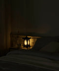 Handmade Korean Wood Lamp With Pagoda Design on bedside table, cozy warm ambient light in a dark bedroom, Asian Oriental decor