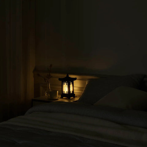 Handmade Korean Wood Lamp With Pagoda Design on bedside table, cozy warm ambient light in a dark bedroom, Asian Oriental decor