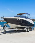 Boat on trailer by water, showcasing Two Pack 5.30-12 Trailer Tires On 12 Inch Rims With Five Lug On 4.5 Inch Bolt Pattern Center Bore 2.95 Inches.