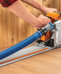 Worker using Click Connect Hose Adapter For FlexiPort Three To Twelve Foot Expandable Pipe attached to a power tool on a table.