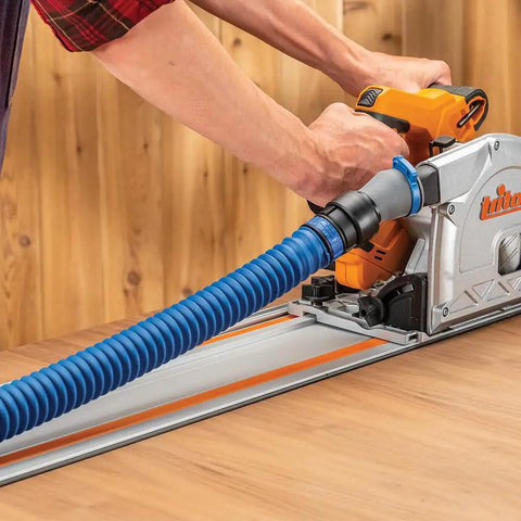 Worker using Click Connect Hose Adapter For FlexiPort Three To Twelve Foot Expandable Pipe attached to a power tool on a table.