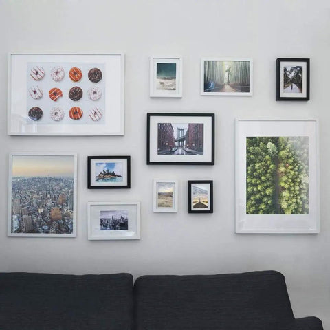 Wall display of framed artworks using Ultimate Picture Hanging Kit With 100 Feet Braided Wire 60 D Ring Hangers 60 Screws And 60 Aluminum Crimping Loop Sleeves For Canvas Paintings And Photo Frames Built For Quick Easy Secure Wall Display