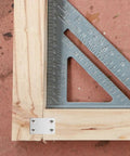 Close-up of Sturdy Stainless Steel Flat Plate Brackets 20-Piece 4-Hole Set in use on wood for DIY home improvement.