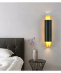Sleek Black Wall Lamp With E27 Socket For Living Room TV Wall And Entryway Glare Free Indoor Sconce mounted above a bed.