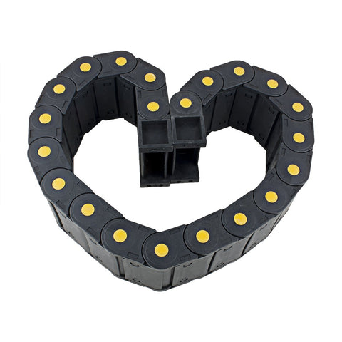 Heart-shaped arrangement of R55 25mm By 77mm Plastic Cable Drag Chain Wire Carrier With Openable Cover Closed Type resting on white surface.