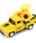 Yellow metal pickup truck with sunflowers, part of Sunflower Metal Farm Truck Decor Set Of Four With Large And Mini Sunflowers Vintage Diecast Style Pickup.