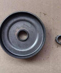Top Notch Clutch Sprocket For Chain Drive Systems With 3/8 Inch Pitch with bearing next to it on brown cardboard.