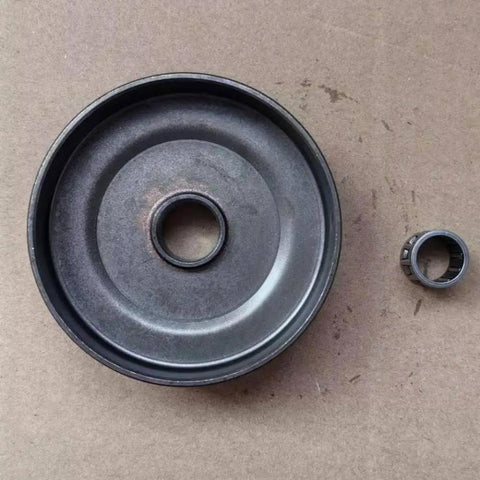 Top Notch Clutch Sprocket For Chain Drive Systems With 3/8 Inch Pitch with bearing next to it on brown cardboard.