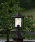 Boss Black Outdoor Post Light With Clear Glass Shade in garden setting