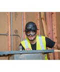 Construction worker wearing clear lens safety goggles with anti fog, scratch-resistant eye protection PPE on job site.