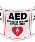 AED sign banner, curved strip with panels reading Automated External Defibrillator and red heart symbol.
