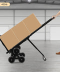 Heavy Duty Stair Climbing Dolly With Ten Wheels For No Sweat Moving, 551 Pound Flat Ground Weight Limit, Foldable Steel Cargo Cart Built Like A Tank For Bulky Furniture And Daily Hauls with boxes tilted on a dolly.