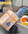 Professional Grade Electric Stair Climbing Dolly Engineered With A Beefy 1200W Brushless Motor That Powers Through Flights While Crushing 880 Lb Hauls Smooth Operation with a loaded box on a sturdy dolly.