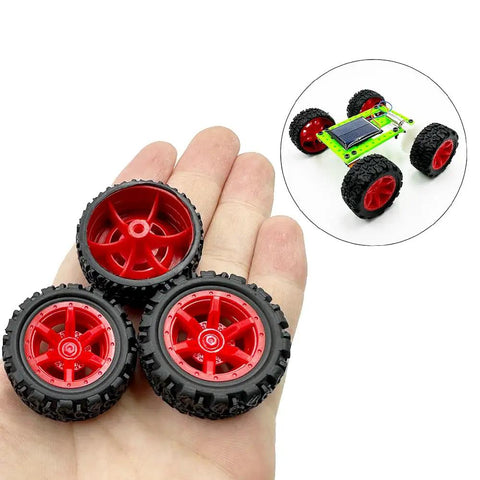 Close-up of 10 Pcs 34mm Rubber RC Car Wheels with 2mm Shafts and 5 Rod Axles Kit on a hand for RC cars and robots.