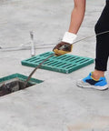 Person using Built Tough Outdoor Drain Cleaning Tape Manual Pipe Snake With Flat Blade 82 Feet Long near sewer drain.