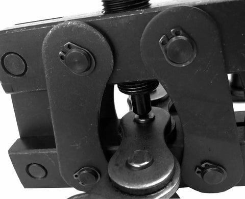 Close-up of Beast Of A Roller Chain Breaker And Detacher for Chain Sizes 100 Through 180 Heavy Duty Tool in action on a chain link