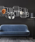 Slick Abstract Line Coat Rack Wall Mount With Integrated Key Holder Mid Century Modern Entryway Hooks For Jackets And Bags Fresh Black Metal Home Accent Vibe Solid Wall Storage Setup For Quick Daily Grabs featuring gray and white design with hats and headphones.