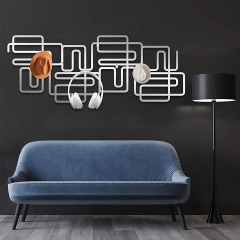 Slick Abstract Line Coat Rack Wall Mount With Integrated Key Holder Mid Century Modern Entryway Hooks For Jackets And Bags Fresh Black Metal Home Accent Vibe Solid Wall Storage Setup For Quick Daily Grabs featuring gray and white design with hats and headphones.