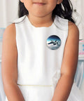 Child wearing Fighter Jets Button Pins 1 Pc 2.4 Inch Round Metal Badges With Personalized Photo Pins, glossy finish, on a white dress.