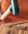 Installation of 3/8 Inch 16 T Nuts 20 Pack Zinc Plated Steel Tee Nut in wood, showing hammer and nut placement.