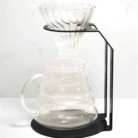 Kick Your Morning Routine Upstairs With This Rock Solid Iron Brew Station Perfect For Home Baristas Seeking Consistent Heat And A Go To Pour Over Setup Always On Point, featuring a heavy duty iron pour over stand with a clear dripper and glass carafe.