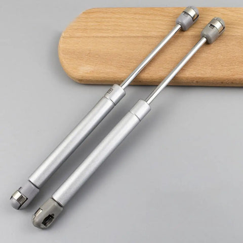 Ultra Sturdy Hydraulic Gas Spring Hinges For Cabinets And Lids With Soft Close Heavy Duty Kitchen Door Struts on wood background