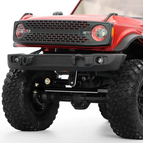 Close-up of Axial SCX24 Steering Servo Upgrade Kit with Metal Gear installed on 1/24 scale RC crawler, showing detailed front view.