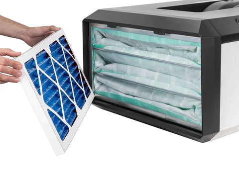 Hand inserting 24x12x1 Electrostatic Outer Air Filter For AFS-1000B And AFS-1000C into HVAC system, blue nonwoven media visible