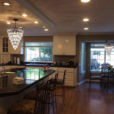 Crystal Chandelier in Farmhouse Bronze, 4 Light Hanging Pendant Fixture illuminating a kitchen space with elegant rustic glam vibe