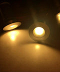 Close-up of warm white Linkable LED Under Cabinet Lights 12V Recessed Mini Downlights Kit Dimmable illuminating a surface