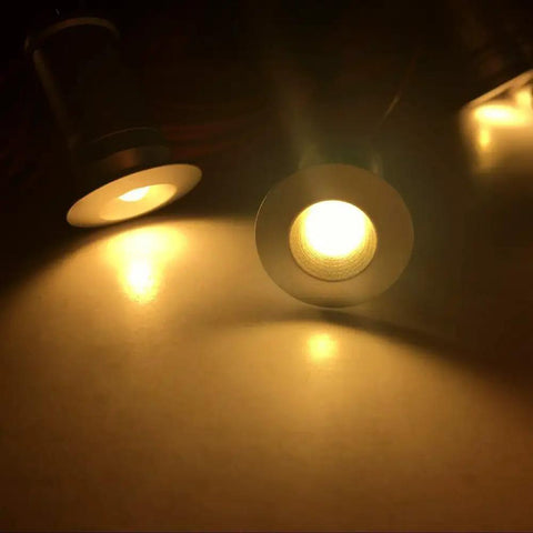 Close-up of warm white Linkable LED Under Cabinet Lights 12V Recessed Mini Downlights Kit Dimmable illuminating a surface