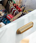 Installed Six Pack 5 Inch Antique Brass Cup Pulls With Distinctive Layered Ribbed Multi Sectioned Design on drawer