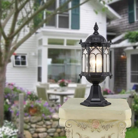 JUDYSSY Security Lights Outdoor/lot Led Flood Light Outdoor Floodlight Spotlight IP67 Waterproof on a decorative pedestal in a garden.