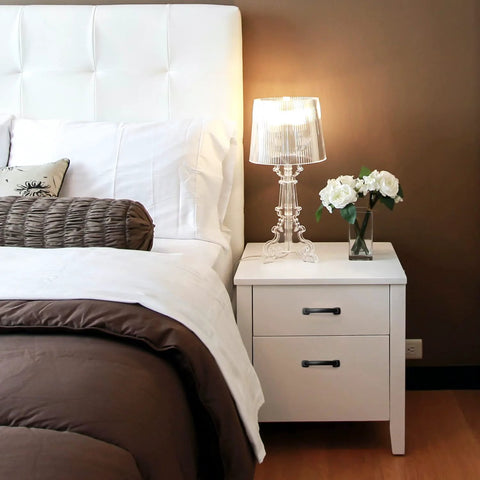 White bedside table with Arch Cabinet Pulls 3 Inch Matte Black Solid Zinc Die Cast flat drawer handles, lamp, and flowers