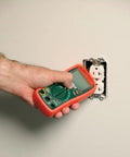 Autoranging Mini Multimeter With Built In Non Contact Voltage Detector Handy Tool For Diy And Pros in use near an outlet.