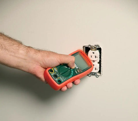 Autoranging Mini Multimeter With Built In Non Contact Voltage Detector Handy Tool For Diy And Pros in use near an outlet.