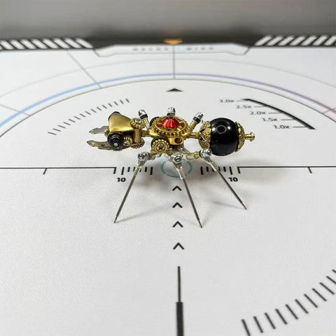 Mechanical Ant 3D Metal Model Kit with 130 Plus Pieces, Steampunk DIY Build for Adults and Teens, Creative Desk Display, Dope Gift for Engineers, Hobbyists, and Collectors. small brass ant model on a calibration mat
