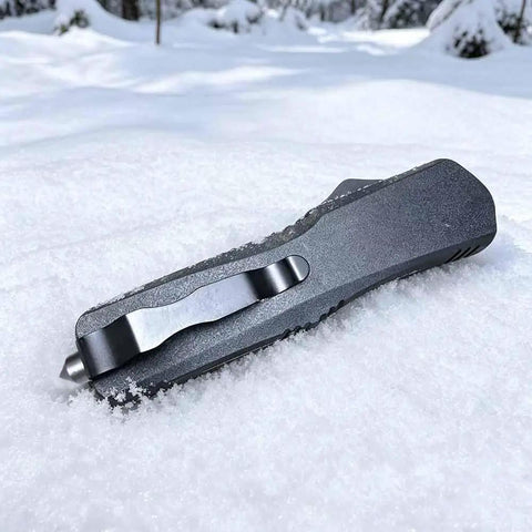 Folding Tactical Knife For Outdoor Adventures Multipurpose EDC Tool For Camping And Hiking Everyday Carry Black Finish Durable 80mm Blade 3mm Thick 18mm Wide High Quality Steel lying in snow