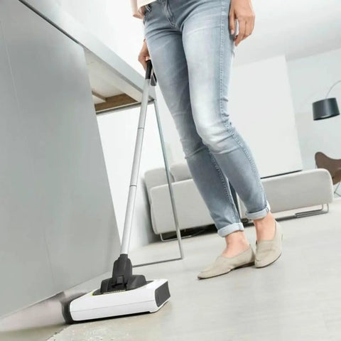 Person using a Cordless Electric Floor Sweeper Broom With Whisper Quiet Rollers For Hardwood Vinyl Tile And Rugs in a living room