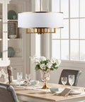 Dining room with Black Drum Chandelier With Adjustable Chain Link, 19-Inch, 5 Lights, White Fabric Shade over table.
