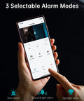 Person holding phone showing 3 alarm modes of Outdoor Wireless Security Camera With 2K Solar Power And 3MP Color Night Vision.