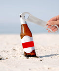 Two Pack V Rod Bottle Opener Set For Bartenders And Home Bar opening a bottle on a sandy beach