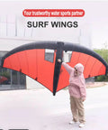 Person holding Inflatable Windsurf Wing With Clear Window For Easy Visibility, Handheld Wing Foil Kite For Surfing And Water Play, Red.