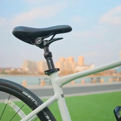 Side view of Lever Actuated Dropper Seatpost With 100mm Drop And 20mm Suspension Travel For Bicycle And E Bike on white bike
